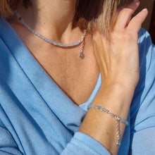 Load image into Gallery viewer, Person wearing a necklace and bracelet with a blue aquamarine