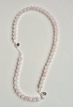 Load image into Gallery viewer, Necklace with pink beads on a light gray background