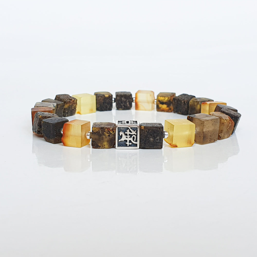 Bracelet with brown and yellow square beads on a white background