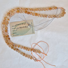 Load image into Gallery viewer, Beaded necklace with a tag on a white background