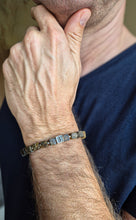 Load image into Gallery viewer, Close-up of a person wearing a bracelet on their wrist with a blurred background